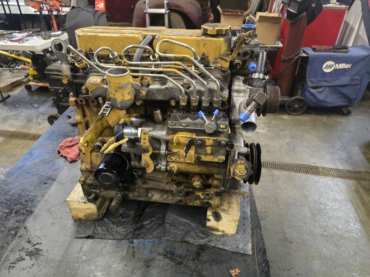 Diesel engine removed from a machine and mounted on a shop bench for hydraulic and engine repair work