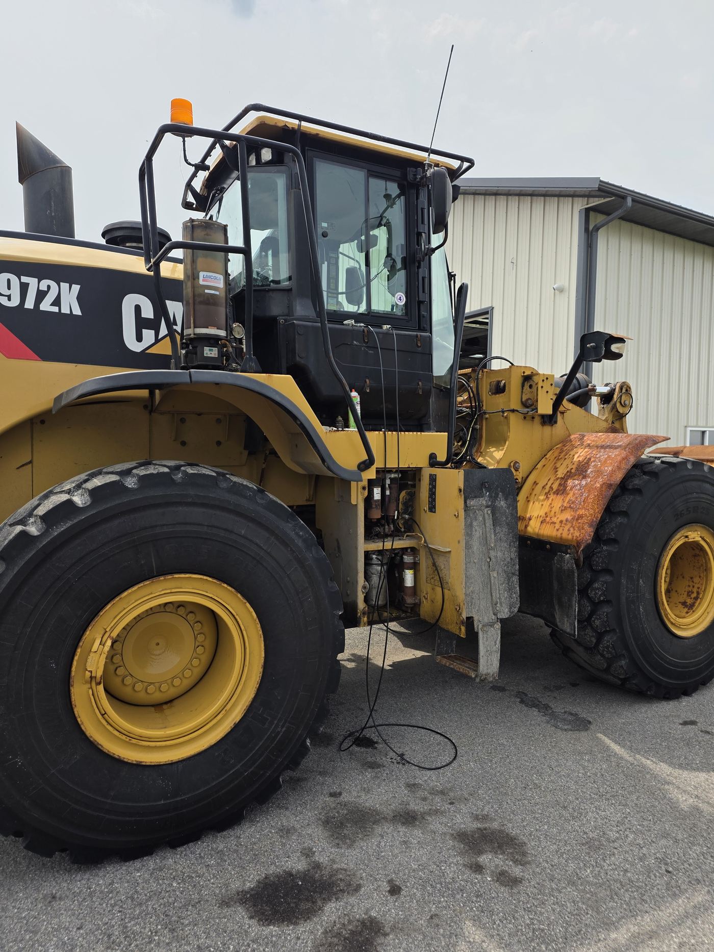 Wheel loader with the rear service doors open during a hydraulic and electrical field service call